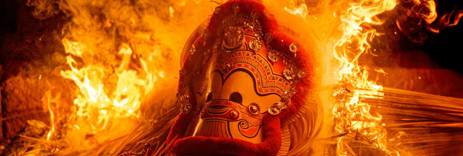 A performer dressed as a deity during a Theyyam ritual in North Kerala