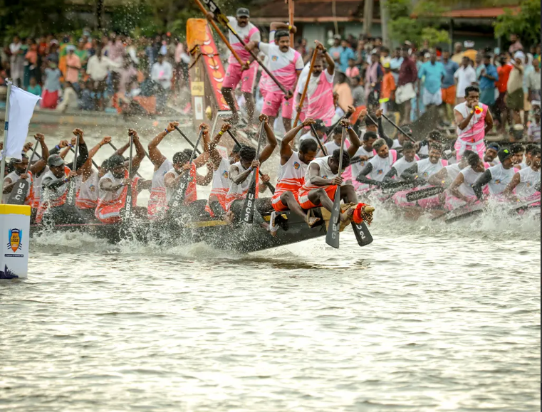 A snake boat race with many rowers on the backwaters of Kerala